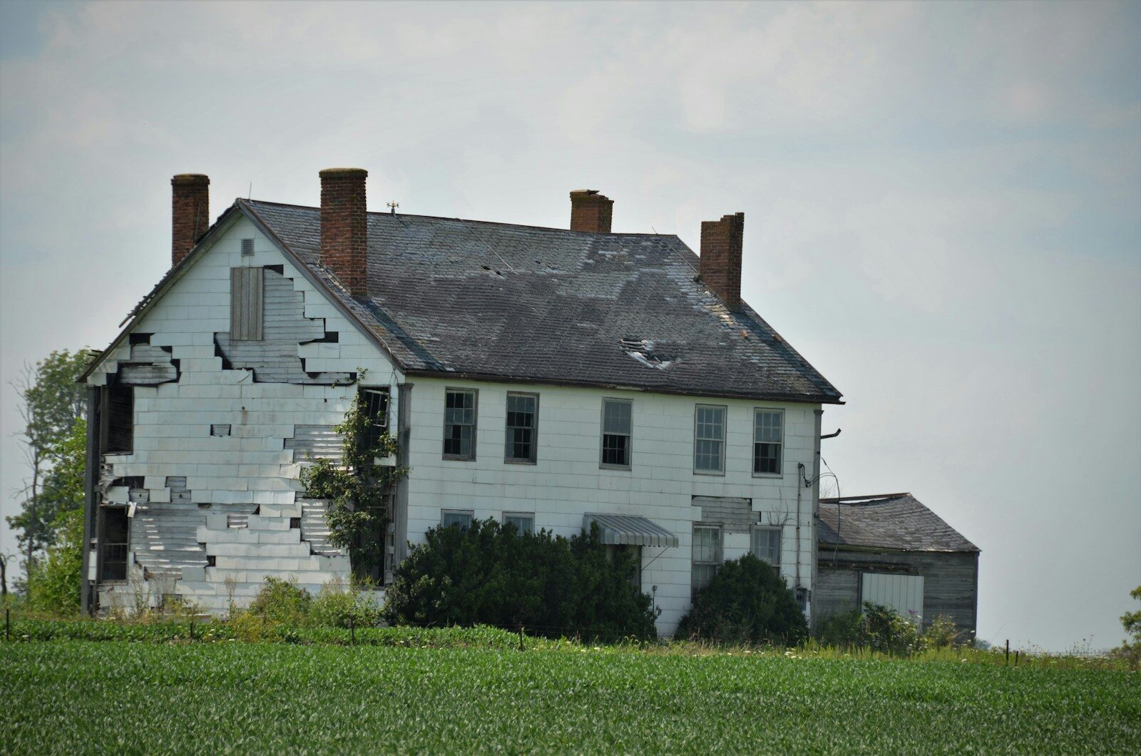 white and gray house on green grass field during daytime